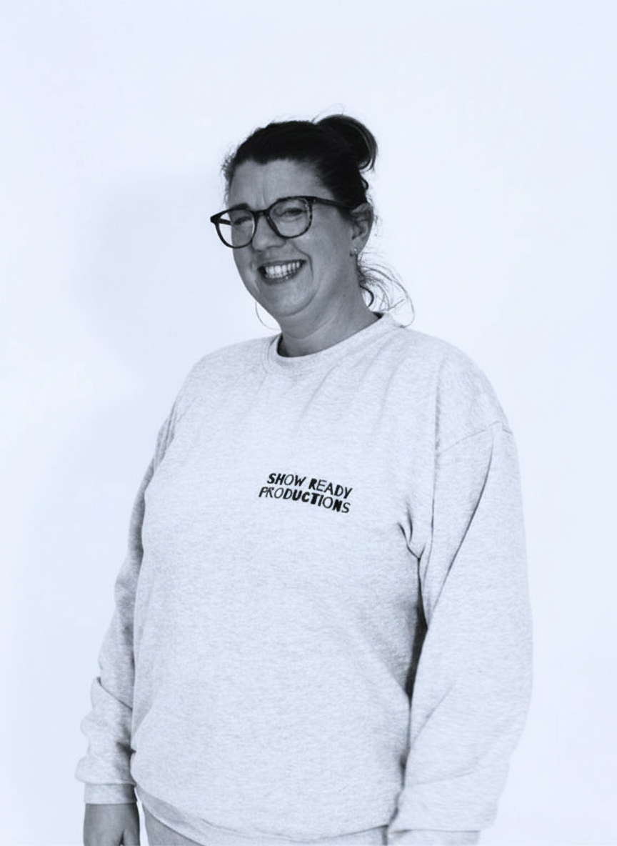 Edit this existing portrait photo so that the person is framed slightly more to the right, resulting in the person appearing centered in the image, while keeping everything else (lighting, colors, background, and cropping) as close as possible to the original.